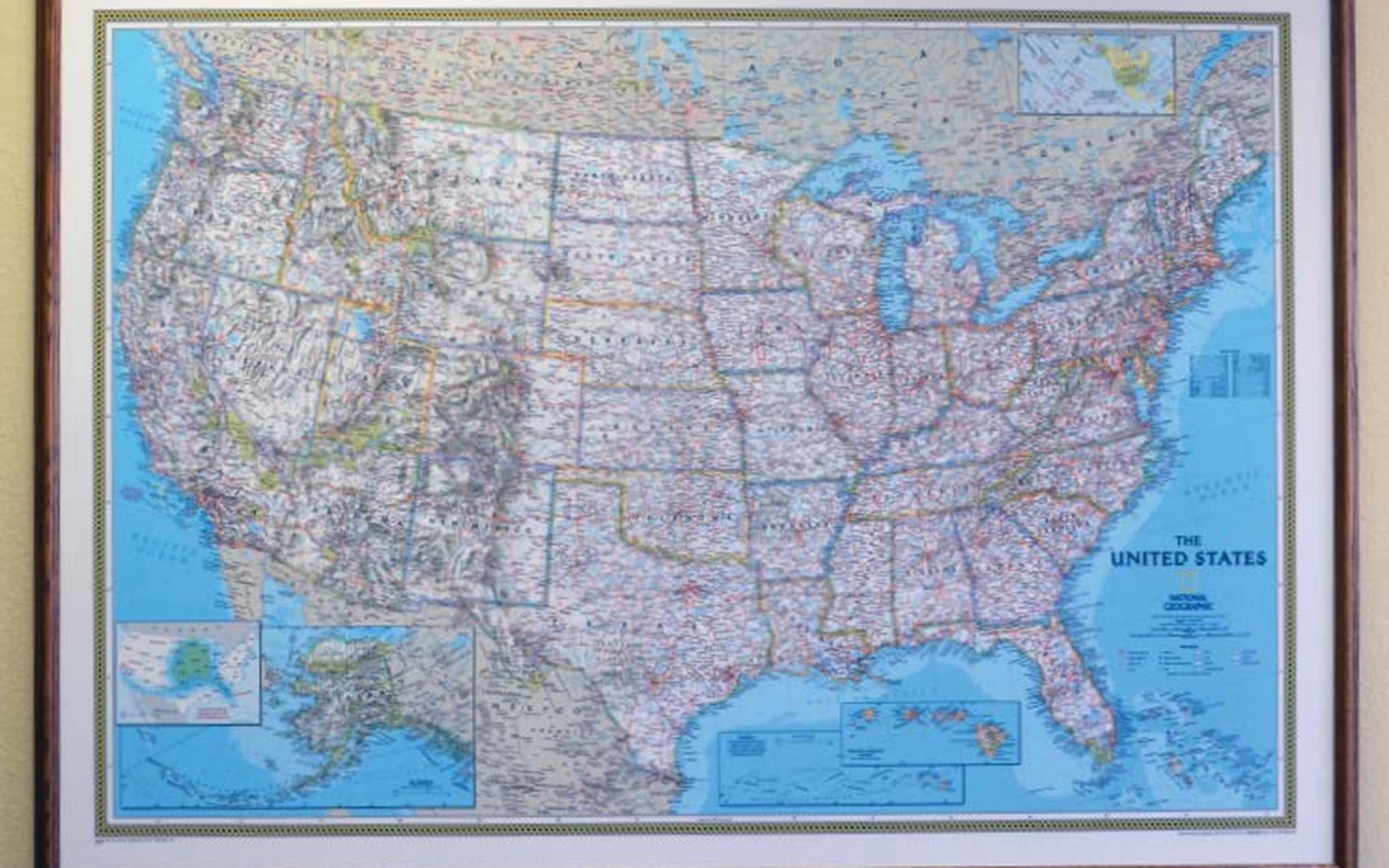 A framed map of the United States hanging on a wall