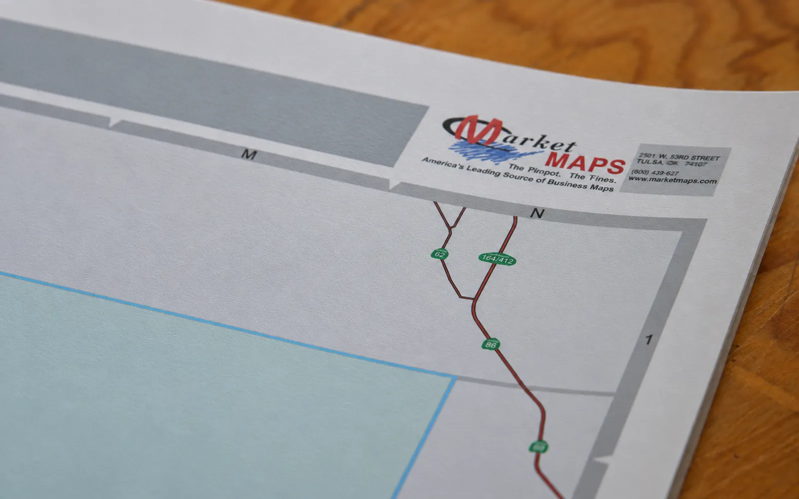 The corner of a matte-finished map with a soft, low-sheen surface