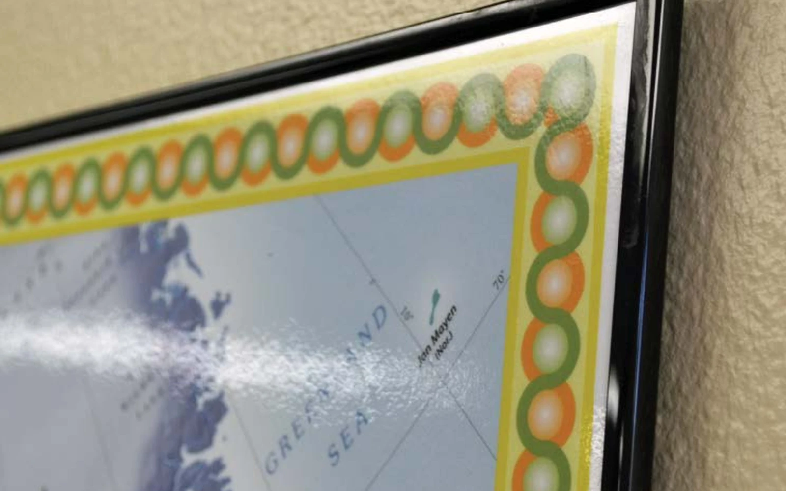 The corner of a framed magnetic wall map