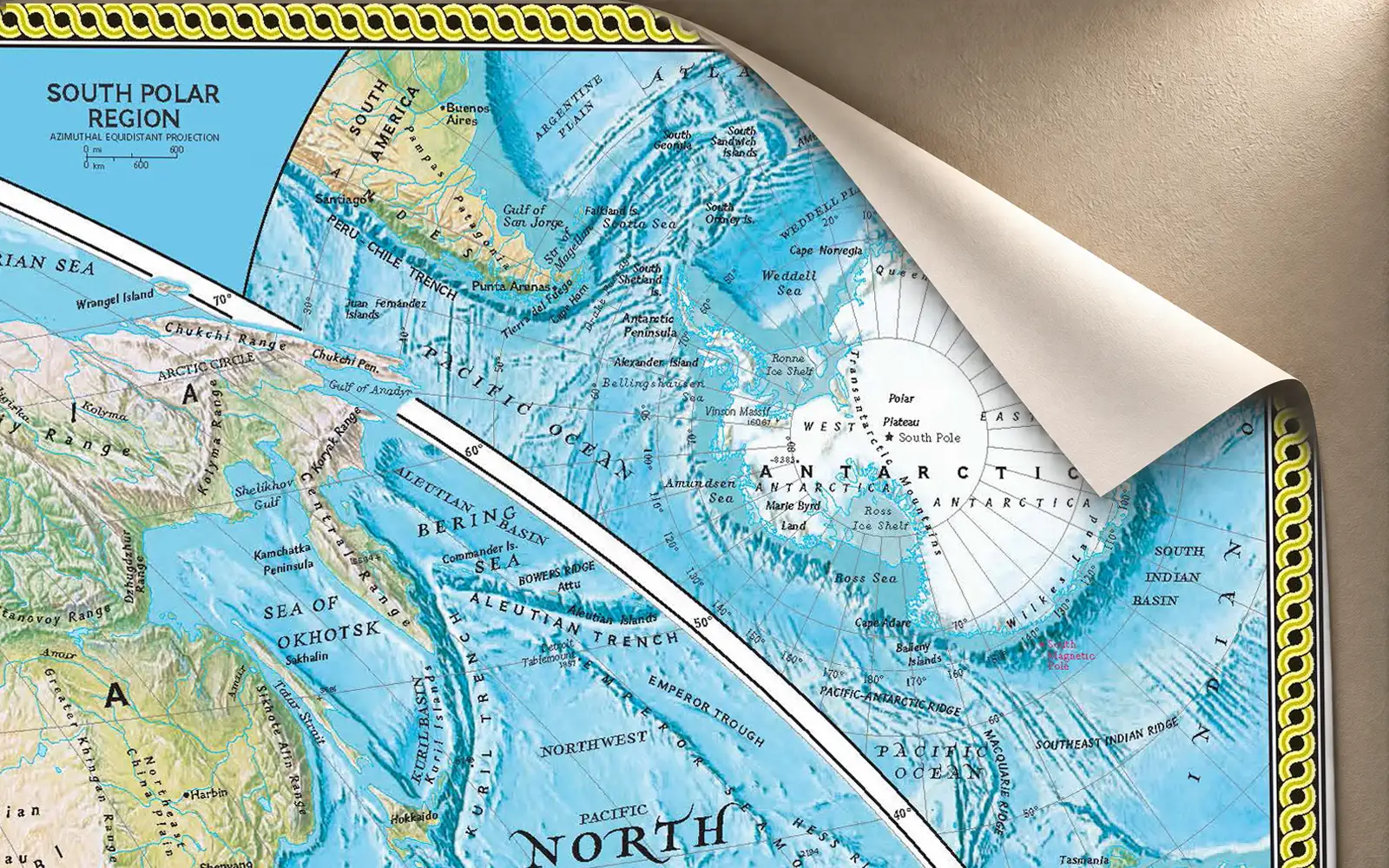 A large map sheet with one corner lifting away from the wall
