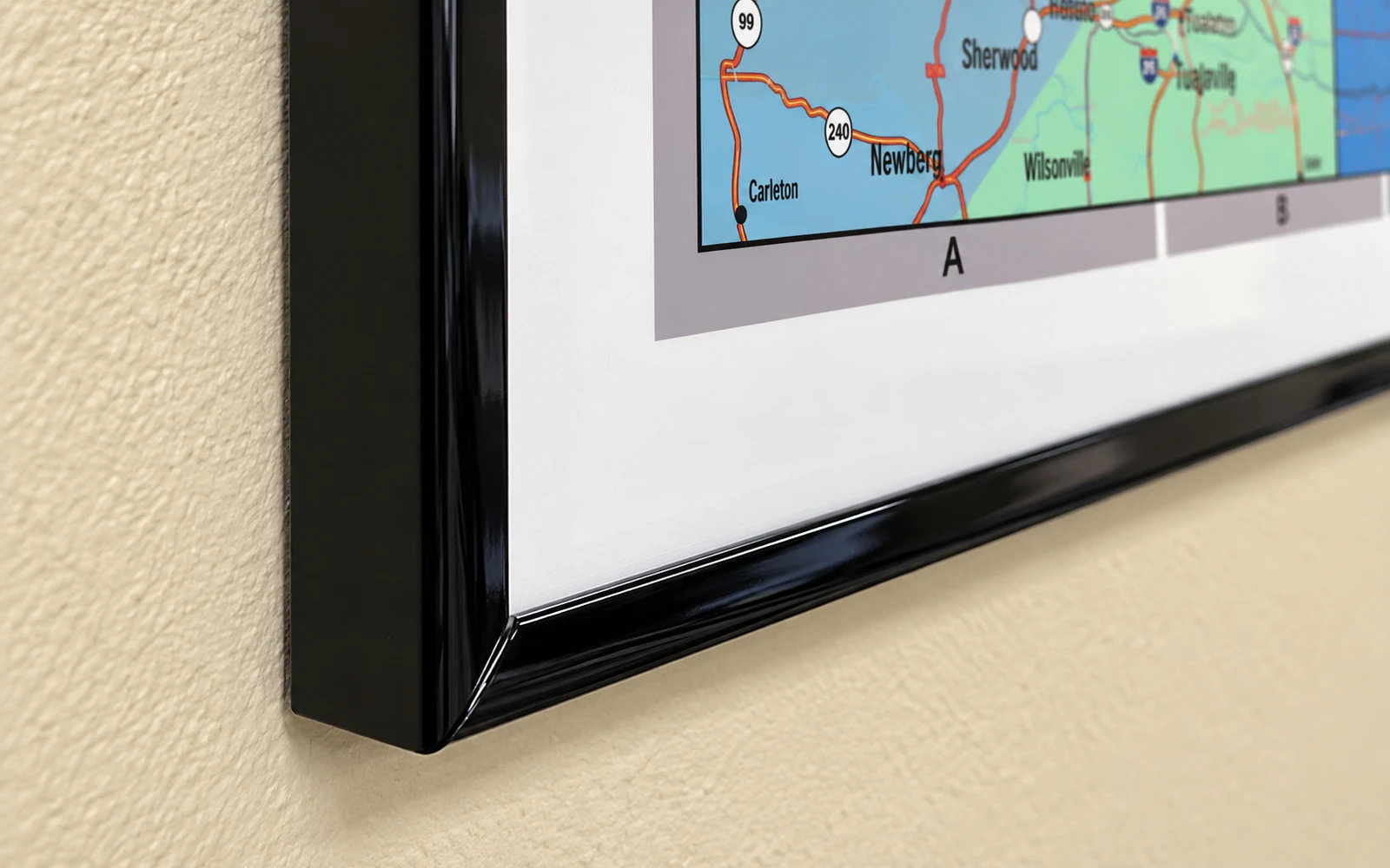 The corner of a mounted map in a slim black plastic frame