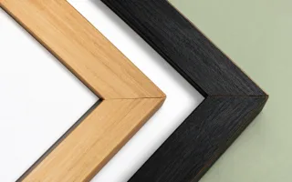 Three plain wood frame corners side by side: natural, black and grey