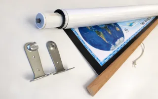 A map rolled onto a spring roller beside its two wall brackets