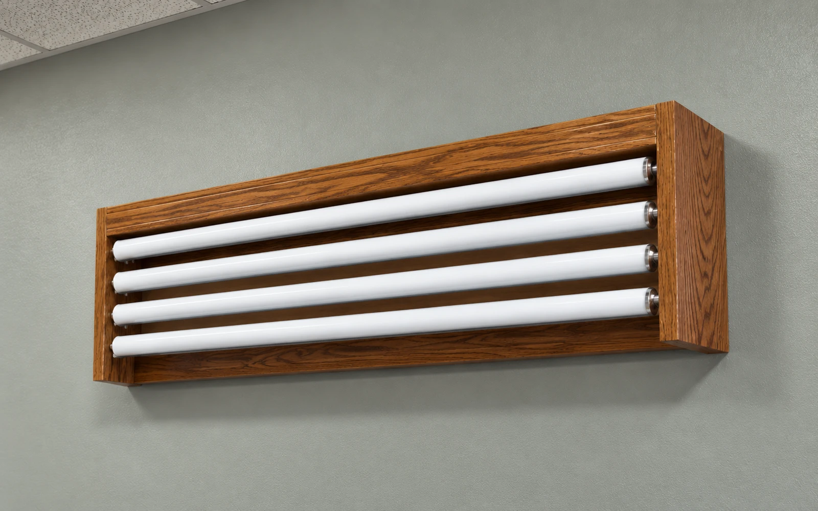 A wooden valance on a wall holding four spring roller maps