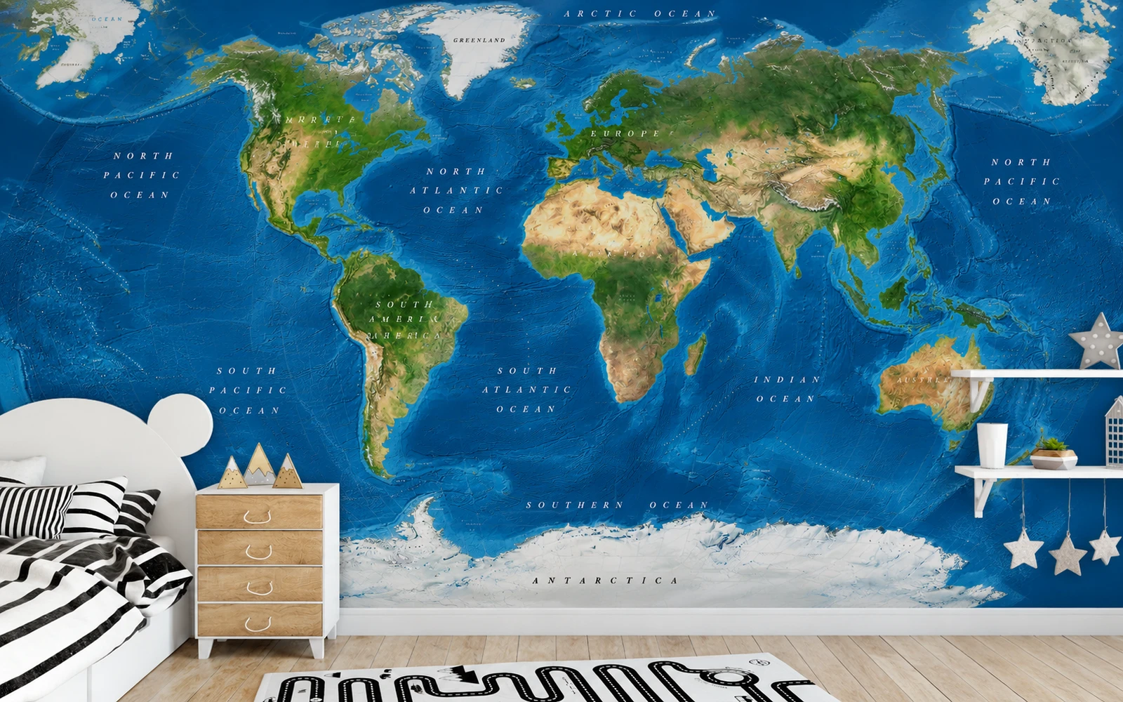 A satellite world map hung as wallpaper across a bedroom wall