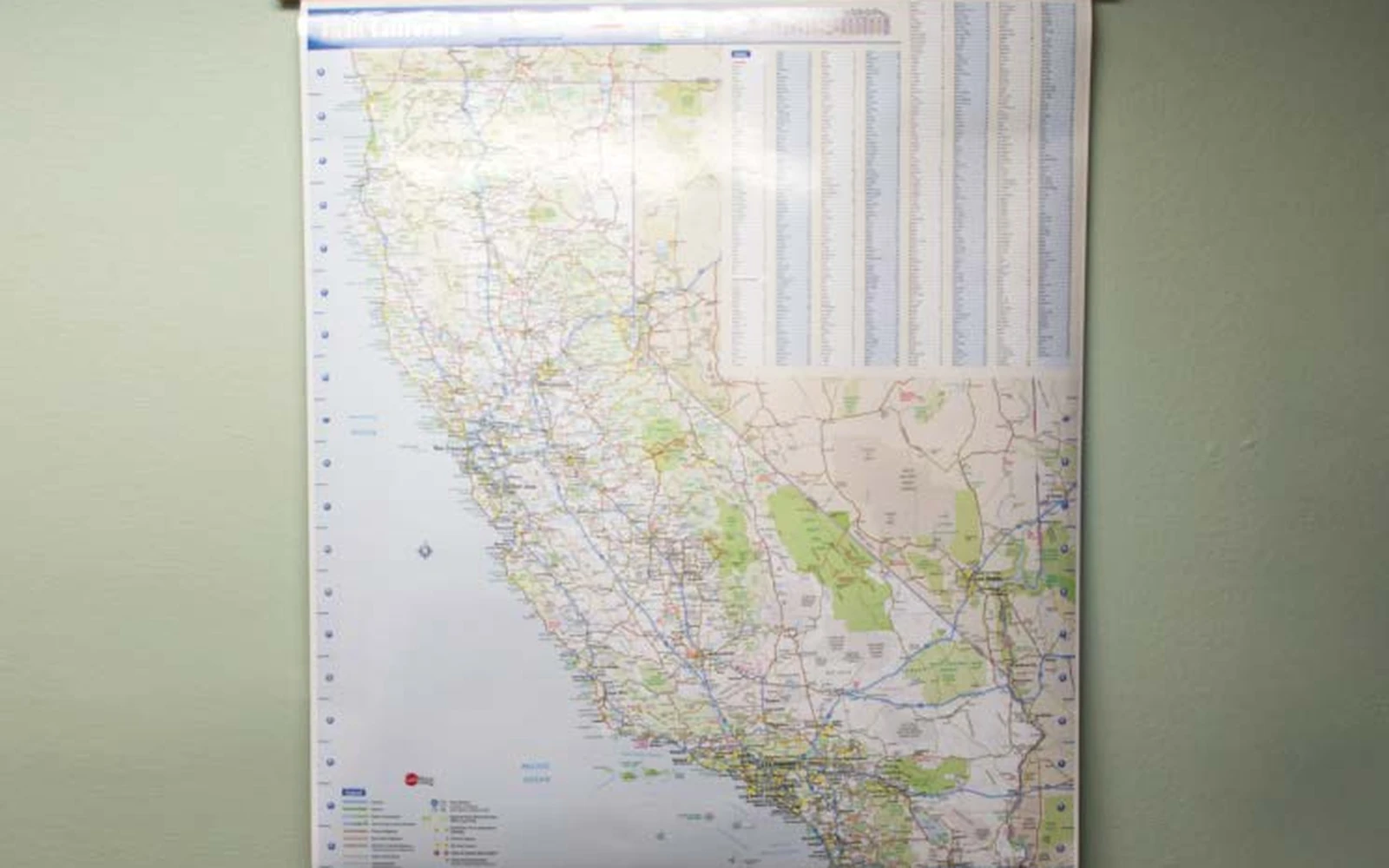 A railed wall map of the western United States hanging on an office wall