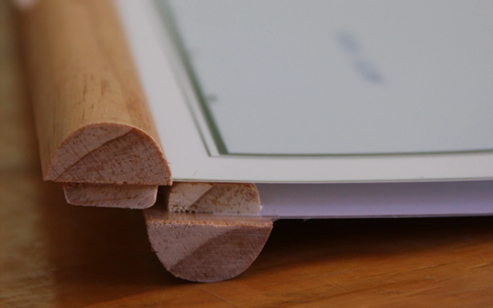 Close-up of the wooden rail along the bottom edge of a map